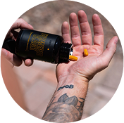 Person Placing Pill in Hand